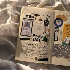 an open book with various stickers and writing on the pages that are covered in white sheets