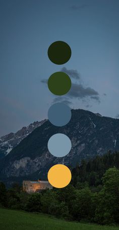 an image of the sky and mountains with different colored circles hanging from it's sides