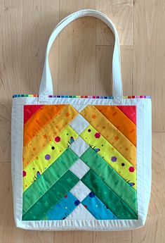 a multicolored bag sitting on top of a wooden floor