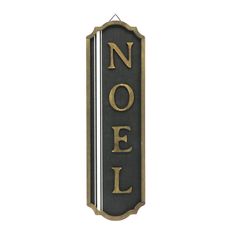 a black and gold sign that says noel on it's side, against a white background