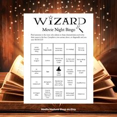 the wizard movie night bingo game is open on top of a table with an open book