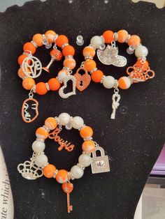 -Three Stack Stretchable Charm Bracelet -Each bracelet has four silver and orange bling charms -Beads are 15mm -Put bracelets on carefully by gently rolling them onto the wrist -Can be worn altogether or separately Personalized Orange Bracelets As Gift, Adjustable Nickel-free Orange Bracelets, Adjustable Nickel-free Orange Bracelet, Personalized Orange Round Bead Jewelry, Orange Bangle Stretch Bracelet For Gift, Personalized Orange Bracelets With Round Beads, Jewelry Fashion Trends, Charm Bracelets, Bead Charms