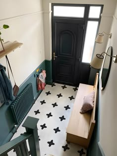 the hallway is decorated in black and white with an interesting pattern on the tile floor