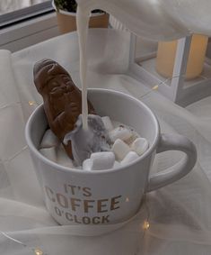 a coffee cup filled with marshmallows and chocolate