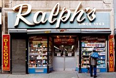 a store front with a man standing in front of it