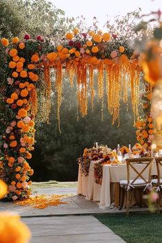 An elegant fall garden wedding arch and aisle featuring rustic autumn wedding decor, with vibrant orange flowers and hanging floral arrangements for an outdoor ceremony. Autumn Wedding Aisle, Outdoor Fall Ceremony, Rustic Autumn Wedding, Fall Ceremony, Aisle Decorations, Rustic Autumn