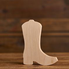 a wooden toy boot sitting on top of a table