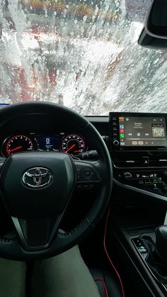 the interior of a car with dashboard, steering wheel and dash lights in front of it