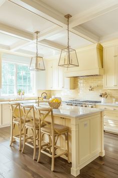 a kitchen with an island and chairs in the center, surrounded by wooden flooring