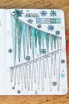 an open notebook with snowflakes and icicles on it