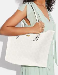 Signature coated canvas with smooth leather detailsInside zip pocketSnap closureHandles with 10" drop13" (L) x 11 1/2" (H) x 6 1/4" (W)Style No. 5696Color: Glacier White Signature Coated Canvas Tote Shoulder Bag, Signature Coated Canvas Tote Shoulder Bag With Zipper, White Coach Tote Satchel, Luxury Signature Coated Canvas Tote Shoulder Bag, Coach City Tote, Tan Tote Bag, Coach Tote Bags With Silver-tone Hardware, Coach Poppy, Suede Tote