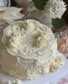 a wedding cake with white frosting and flowers