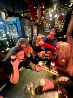 a group of people sitting at a table with drinks