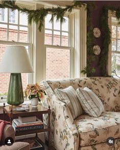 a living room filled with furniture and christmas decorations