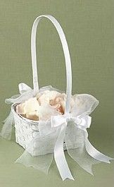 a small white basket filled with baby's breath