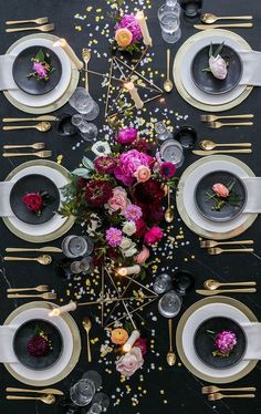 the table is set with flowers and candles