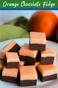 orange chocolate fudge squares on a plate with an orange in the background and text overlay that says orange chocolate fudge