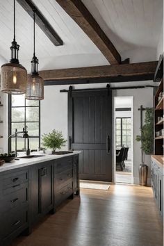 Farmhouse kitchen with mixed industrial and rustic lighting fixtures Black Farm Kitchen, Modern Farmhouse Kitchen With Island, Modern Rustic Interior Design Kitchen, Modern Dark Farmhouse, Industrial Cottage Style Kitchen, Industrial Farmhouse Style, Farmhouse Kitchen Black Hardware, Black And Wood Kitchen Cabinets Rustic, Modern Industrial Farmhouse Kitchen