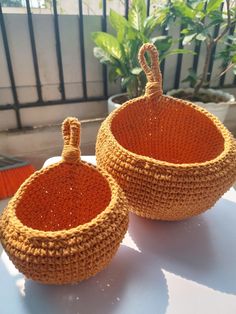 two woven baskets sitting on top of a table