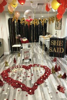 balloons and streamers in the shape of a heart are on display at a valentine's day party