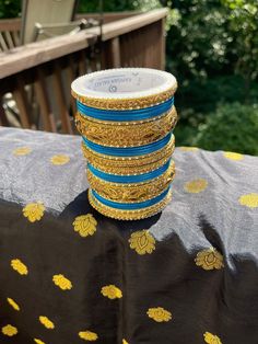 This pair of blue and golden bangles is the perfect accessory to add a touch of elegance to any outfit. Crafted with a metal base and stone detailing, these bangles are sure to become a staple in your jewellery collection. With a diameter of 2.8, these bangles will add a stylish finishing touch to any look.  Features:  - Metal base  - Stone detailing  - Diameter: 2.8  - Stylish finishing touch  - Elegant accessory Mirror Work, Bangle Set, Brown Kraft, Elegant Accessories, Metal Base, Bangle Bracelets, Jewelry Box, Jewelry Collection, Bangles