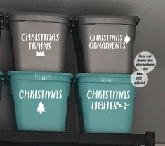 three buckets with christmas lights and christmas ornaments on them are labeled in white letters