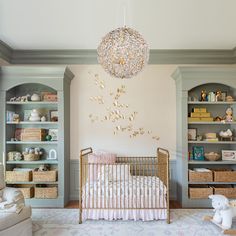 a baby's room with a crib and shelves