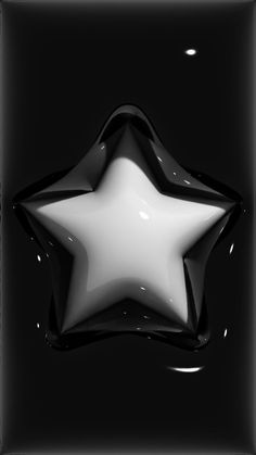 a black and white photo of a star with water droplets on it's surface