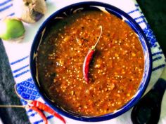 a blue bowl filled with red chili sauce