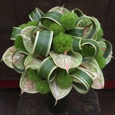 a bouquet of green and white flowers in a vase