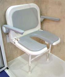 a shower seat with armrests and back rests on the floor next to a door