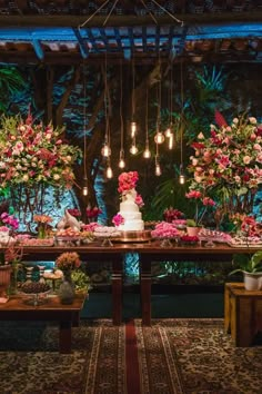 a table with flowers and lights hanging from it