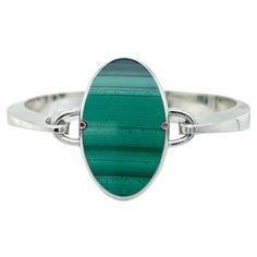 Chic yet Timeless, a contemporary classic Piece, Natural Hand Inlaid Malachite Oval Cut, two natural round ruby in a Solid Handcrafted, Sterling Silver Bangle Bracelet Setting. In our smart Tobacco suede Leather Box and Pouch. Bracelet Weight: Troy Ounces 1.47 Lenght: 7.87 inches, 20cm This unique piece can be engraved on request. Malachite Oval 35x20mm, 1.377x0.787inches Silver Bangle Bracelet, Sterling Silver Bangle Bracelets, Sterling Silver Bangle, Leather Box, Contemporary Classic, Sterling Silver Bangles, Silver Bangle, Oval Cut, Bangle Bracelet