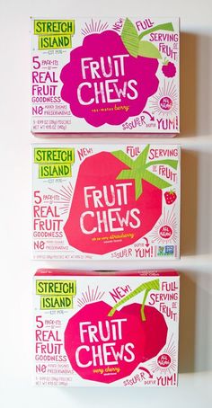 two boxes of fruit chews sitting on top of a white shelf next to each other