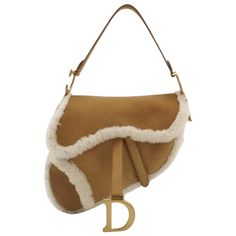 Dior Saddle 2020 Shoulder Bag Shearling Brown and While These are professional photos of the actual bag. Add a wild touch to your style with this Dior Saddle bag. Unleash your inner risk-taker with this bold and chic statement piece designed by Christian Dior, paying tribute to an old classic by John Galliano. Perfect winter accessory CONDITION: EXCELLENT This vintage Dior saddle is in excellent condition with light signs of use. Some stains on the shearling which is characteristic of this material. The white fur part is clean DETAILS DIOR Saddle Year 2020 shearing, leather Suede leather Silver-tone hardware Wdith: 25cm x Height: 22cm x Depth: 6cm ACCESSORY: dust bag, Dior card Christian Dior Paris, Dior Saddle, Maria Grazia Chiuri, Louis Vuitton Keepall, Maria Grazia, Raf Simons, John Galliano, Camel Color, Saddle Bag