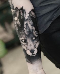 a man with a wolf tattoo on his arm