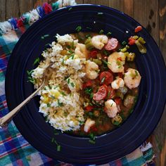 a blue plate topped with rice and shrimp