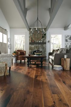 a living room filled with furniture and a stone wall