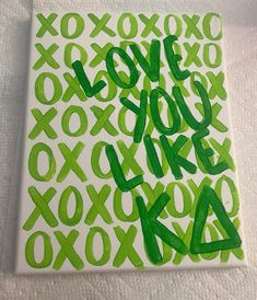 a painting with green letters and numbers painted on white canvases that read love you like xoxo