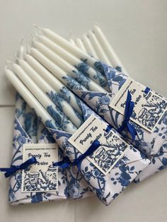 several blue and white candles with tags on them