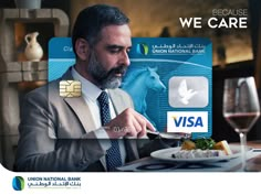 a man cutting into a plate with a credit card in front of him