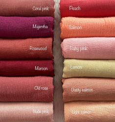 folded towels with names on them in various colors and sizes, including pink, red, orange