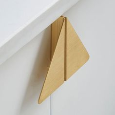 a wooden object hanging from the side of a wall