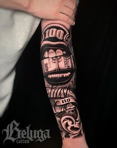 a person with a tattoo on their arm holding up a money bill in his hand