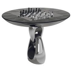 a chess board on top of a table with metal pieces in the shape of an egg