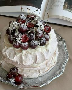 the cake is decorated with cherries and powdered sugar on it's edges