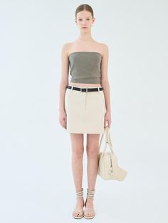 This is a mini skirt made of cotton blend material. This skirt has basic details and a minimalist design, making it easy to coordinate with a variety of tops.- Pockets on both sides for practical use- Can be styled with a belt- Available in 3 colors: Ivory, Beige, Black Chic Mini Skirt With Belt Detail For Work, Cotton Fitted Belted Mini Skirt, Belted Fitted Cotton Mini Skirt, Fitted Cotton Belted Mini Skirt, Chic Skirt With Belt Detail, Mini Length, Fitted Cotton Skirt With Belt, Belted Cotton Mini Skirt, Fitted Belted Beige Mini Skirt, Fitted Beige Belted Mini Skirt