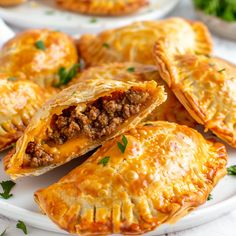 several pastries on a white plate with parsley