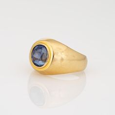 This is part of Chairish’s Fine Jewelry assortment.  Stylish vintage natural Ceylon sapphire signet ring (circa 1990s) crafted in 18 karat yellow gold.   Oval mixed cut natural sapphire measures 8.5mm x 7.8mm x 6.6mm (estimated at 3.50 carats). The sapphire is medium blue in colour, lightly included, good cut and bezel set in the centre. Colour and inclusions are typical of sapphires from Ceylon (Sri Lanka). There is no evidence of any treatments to the stone.     Included with the purchase of t Classic Domed Sapphire Ring With Polished Finish, Classic Domed Sapphire Ring, Formal Yellow Gold Domed Sapphire Ring, Domed Sapphire Ring As A Gift, Classic Domed Yellow Gold Sapphire Ring, Classic Yellow Gold Domed Sapphire Ring, Polished Yellow Gold Sapphire Ring For Formal Events, Polished Yellow Gold Sapphire Ring For Formal Occasions, Formal Yellow Gold Sapphire Ring With Polished Finish