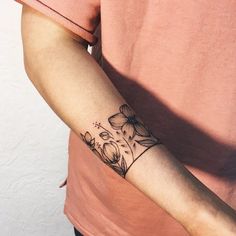 a person with a flower tattoo on their arm